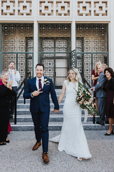 Wedding Photographer, bride and groom leave church with surrounding crowd cheering