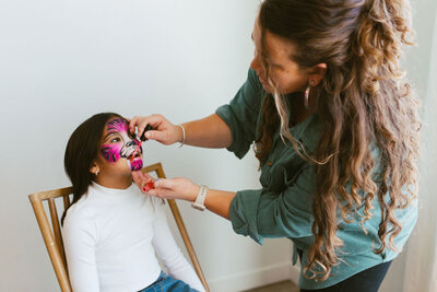 Little girl getting a tiger face painting