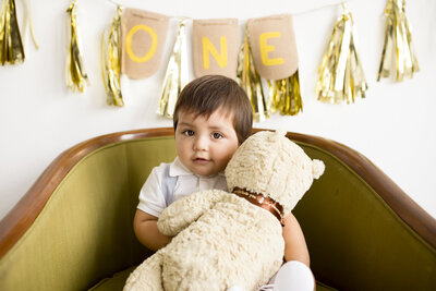 toddler holding teddy bear