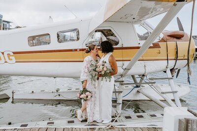 adventure brides share a kiss on a seaplane