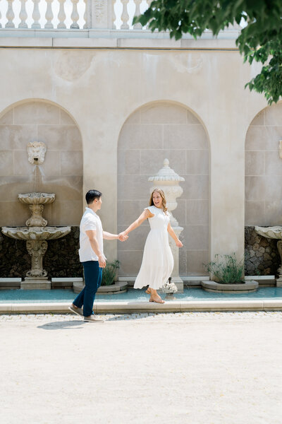 Man and woman walking hand in hand during Cape May engagement session