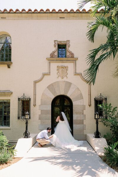 tampa florida wedding photographer helping bride with gown