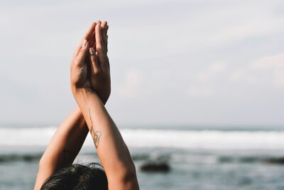 woman doing yoga on the beach