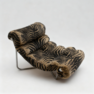 A woman's hand holding one pair of high heels. The heels are black with straps.