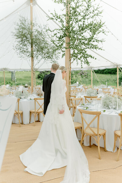 Bride and Groom take in their beautiful sailcloth sperry tent wedding setting on their private estate wedding in Scotland, planned by one of the UK's best wedding planners, Laura McCranor Events. Image by multi-award winning luxury wedding photographer uk, Jill Cherry Porter.