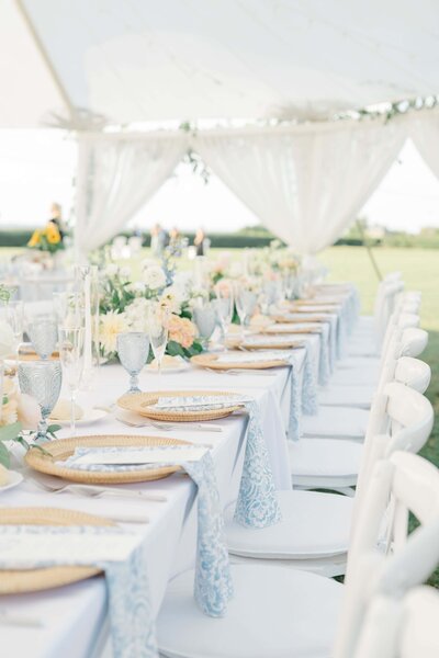 Beautiful wedding reception details at the Eisenhower House in Newport, Rhode Island. This image captures an elegant tablescape featuring delicate floral arrangements, champagne flutes, and intricately designed table settings. Felisha, a destination wedding photographer based in New England, specializes in capturing timeless moments of love and celebration in Rhode Island, Boston, and worldwide.
