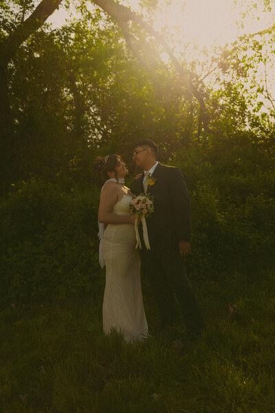 Man and woman romantically spin around, laughing in the middle of a  flowery field