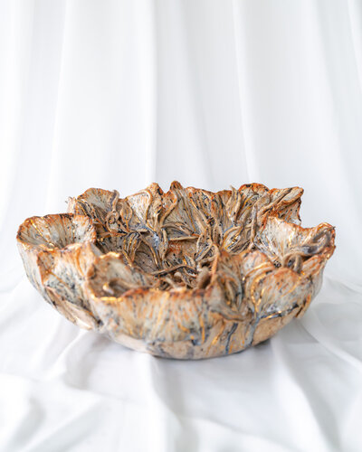 Product photography showcasing a collection of Gerda Satunas' European-inspired ceramic sculptures, highlighting texture and detail.
