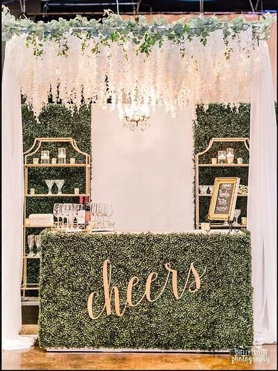 Bliss Bridal 2021 at Mayborn Center Shelley Taylor Photography White Bar Covered in Boxwood Bookshelf Cheers Sign Wisteria Structure Chandy