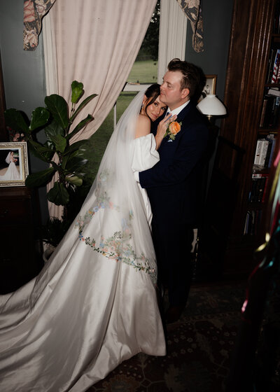 A newly married tennessee couple embrace in a trendy editorial flash portrait at a historic family home in pulaski, tn