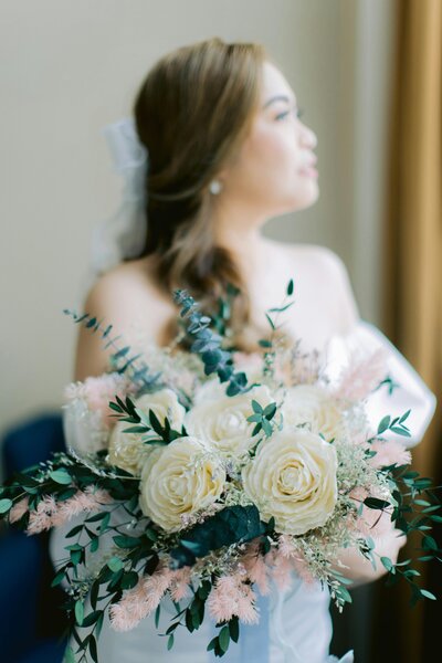 Bride holds a beautiful  bouquet  during her Galveston wedding.