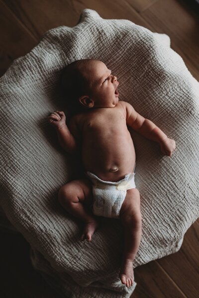 San Antonio newborn baby lying down and yawning