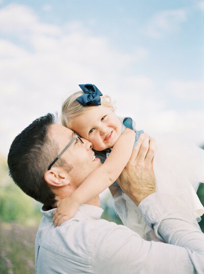 dad and toddler daughter candid smiling playful film photo in seattle