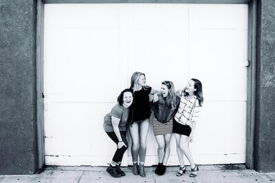 Four women entrepreneurs laughing together, representing The Launchpad Society community