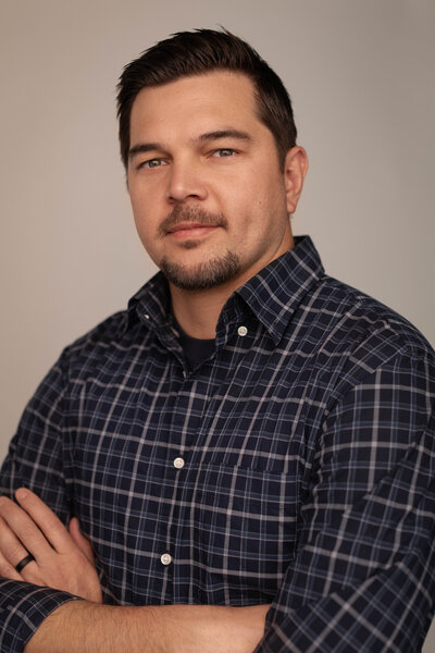 Man sitting for headshot in a chair