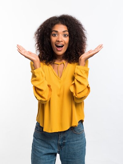 beautiful-african-american-woman-with-afro-hair-in-yellow-wear-smiling-pleasantly-surprised-to-camera_t20_bAZW2B (1)