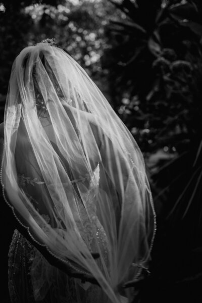 Mother helping Bride with her  beautiful long veil on her wedding day in a castle Southern California