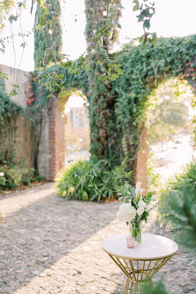Green plants growing on brick archways with golden sunlight at Summerour Studio outdoor space