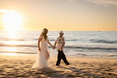 Couple kissing in the ocean during their romantic beach photo session in Puerto Vallarta, captured by Honey I Do