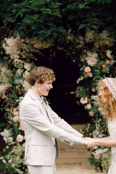 Groom Jon shares a candid laugh during his backyard wedding in Richmond, Virginia, exemplifying documentary-style wedding photography.​

