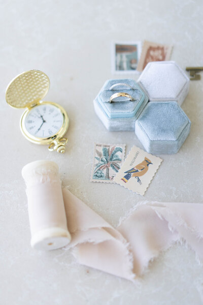 This photo was taken by Destination Wedding Photographer Aline Botti. Aline will bring these details to photograph on your wedding day. It includes a pocket watch, multiple ring boxes, tiny postal cards, etc. This photo was taken in Punta Cana, DR.