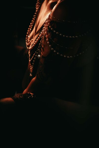 Empowering boudoir portrait of a woman in Kansas City studio wearing a pearl and gem piece from the Heiress Collection Closet