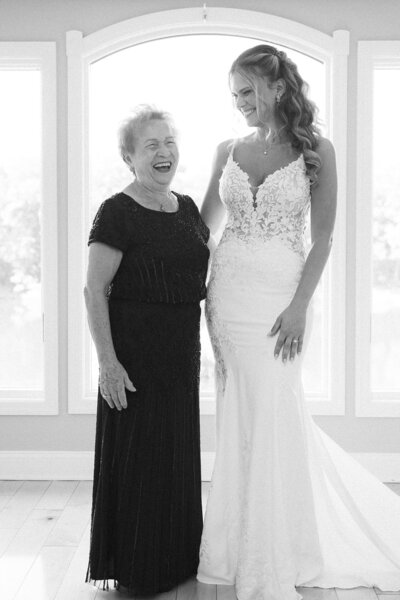 a bride laughing with her grandmother on her wedding day