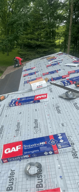 Roofing crew installing a new roof with GAF materials at Black Bear Roofing project site.