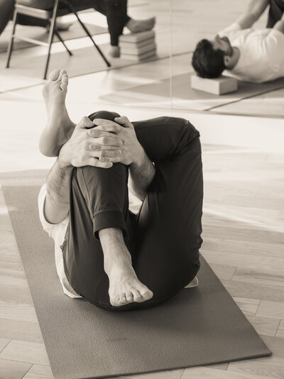 man in laying down yoga pose