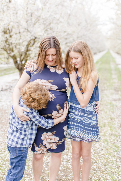 family maternity portrait in blossoms