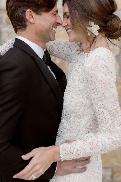 Bride looks over her new husband shoulder and smiles