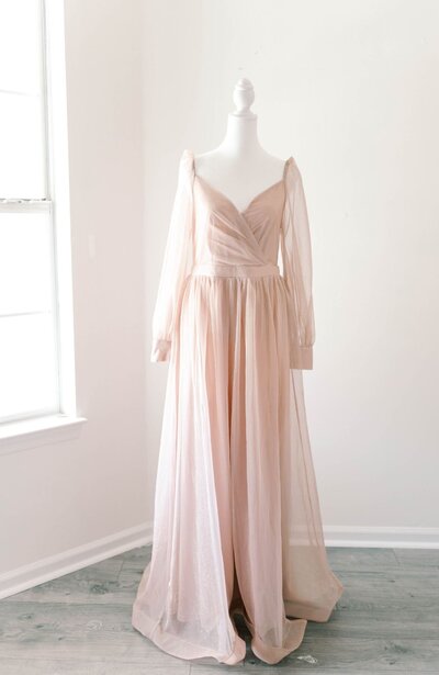 Women's light pink, long sleeve wrap gown.