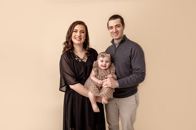 mom, dad and baby posing in studio by Philadelphia Family Photographer