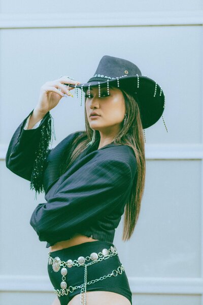 A concert goer tips their rhinestone studded cowboy hat
