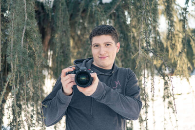 Jacob Metzger holding a camera.