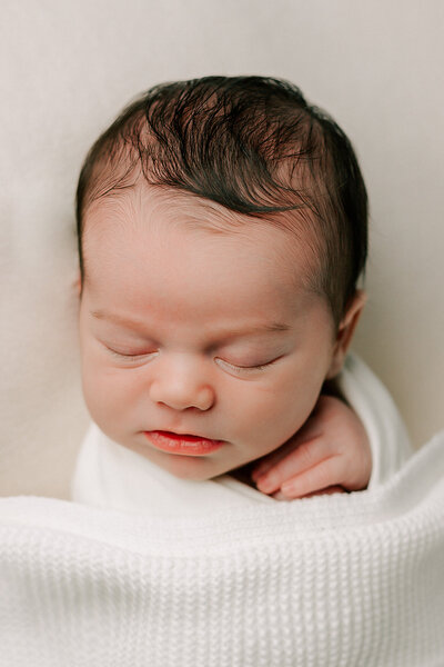 Newborn baby sleeps during his session with Chelsey Kae Photography
