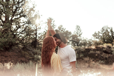 couple holding hands kissing