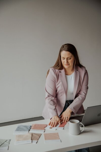 Jessica Young organizing fabric samples at a desk