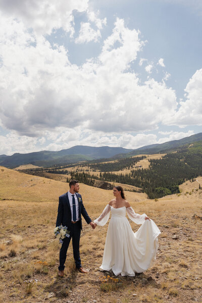 photo of a bride and groom standing in the san juan mountains taken by an elopement photographer near me 