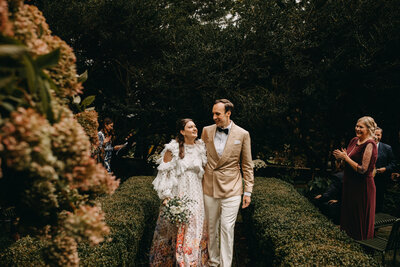 Backyard CT wedding couple walking down garden aisle with Connecticut Wedding Photographer