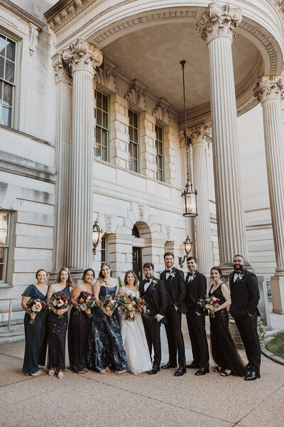 Wedding party poses in front of Anderson House wedding venue in DC