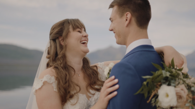 bride and groom looking at each other laughing