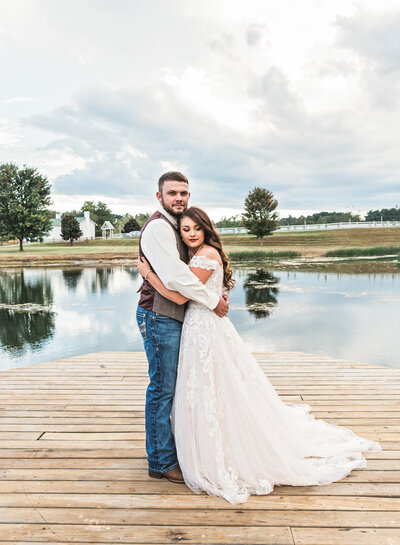 couple embracing on a lake looking at the camera