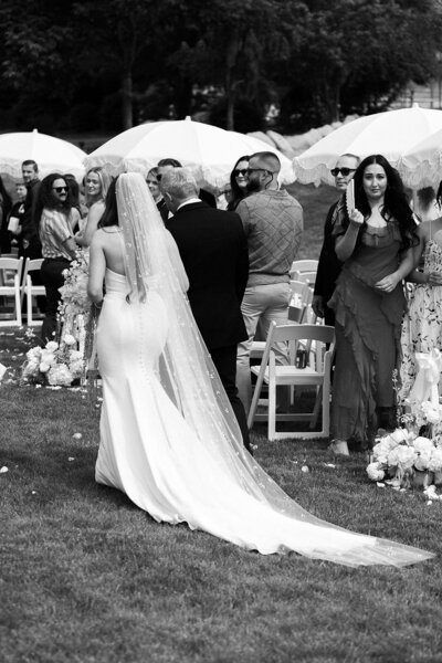 Bride and Groom Pose in Front of Barn