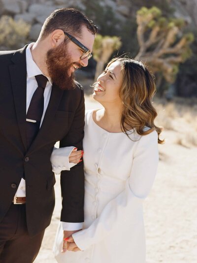 couple spinning on beach and smiling