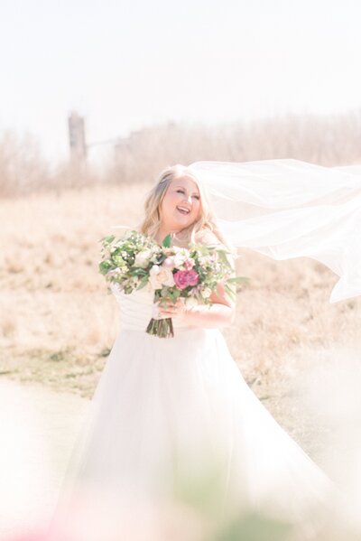 bride smiling and holding bouquet