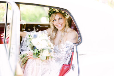 This beautiful portrait captures a bride sitting inside a luxury vehicle at Prince’s Island Park, just outside the River Café. Smiling in anticipation as she waits to be met by her groom, the moment reflects the joy and elegance of their luxury wedding day.