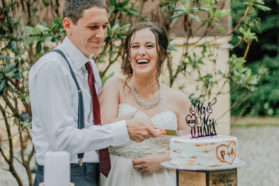 bride and groom cutting their wedding cake