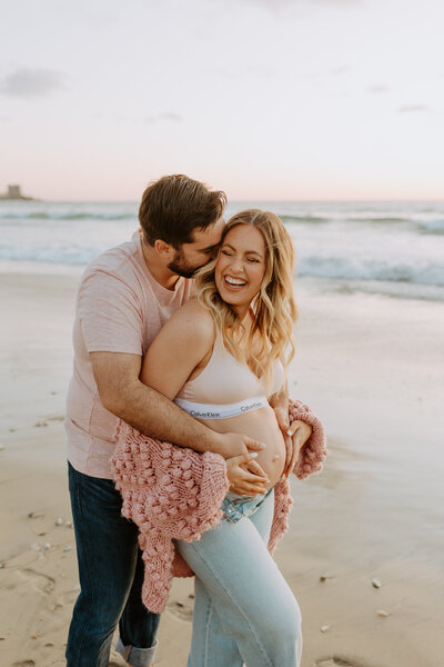 Natural Candid Documentary Family Maternity Baby Pregnancy Announcement Photo shoot at La Jolla Windansea beach at sunset - Couples Mom and Dad San Diego Maternity Photographer