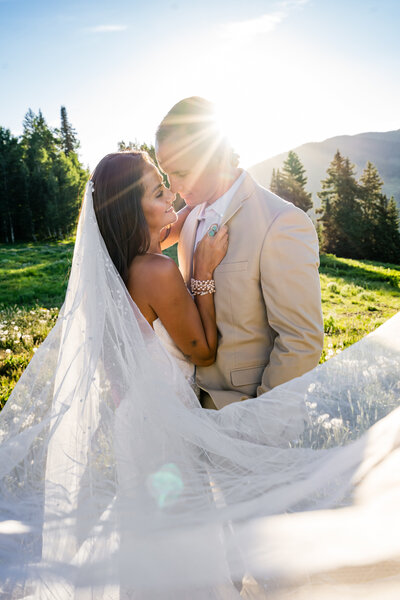Golden hour wedding portrait in Crested Butte with bride’s veil flowing in the light, captured by Colorado micro-wedding photographer